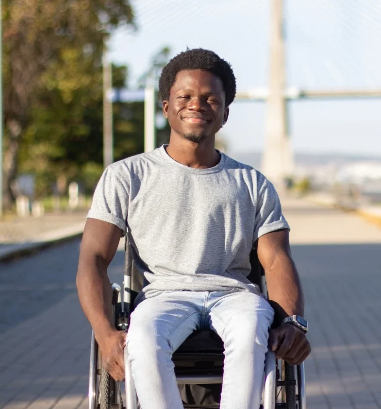 Disabled man in wheelchair smiling at camera
