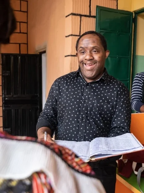 Disabled man with down syndrome talking with support worker